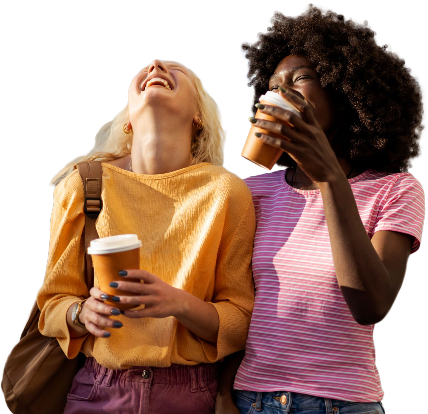 Two friends laughing and holding cups of coffee